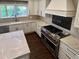 Gourmet kitchen with custom cabinets, marble countertops, and high-end appliances at 5660 E Burlington Dr, Castle Rock, CO 80104