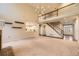 Open-concept living room featuring a staircase, large windows, and access to the kitchen at 5660 E Burlington Dr, Castle Rock, CO 80104