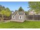 Backyard featuring a cute and functional storage shed with a wooden platform and a shingled roof at 5660 E Burlington Dr, Castle Rock, CO 80104