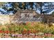 Stone sign surrounded by colorful flowers with the name of the community: Founders Village at 5660 E Burlington Dr, Castle Rock, CO 80104