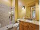 Well-appointed bathroom features a tile shower and wood vanity with granite countertop at 3395 Timbergate Trl, Evergreen, CO 80439