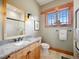 Well-lit bathroom featuring a vanity with granite countertop, and a glass-enclosed shower at 3395 Timbergate Trl, Evergreen, CO 80439