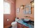 Stylish powder room with vessel sink, granite countertop, and decorative mirror and lighting fixtures at 3395 Timbergate Trl, Evergreen, CO 80439