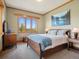 Comfortable bedroom with serene views, showcasing ample natural light and tasteful decor at 3395 Timbergate Trl, Evergreen, CO 80439