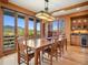 Bright dining room with large windows and seating for eight at 3395 Timbergate Trl, Evergreen, CO 80439