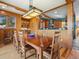 Spacious dining room with a wooden table, chairs, and decorative lighting, perfect for Gathering gatherings at 3395 Timbergate Trl, Evergreen, CO 80439