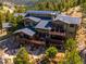 Elevated home features multi-level decks and patios, solar panels, and scenic mountain views at 3395 Timbergate Trl, Evergreen, CO 80439