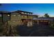 Exterior view of home featuring attached garage and basketball court on driveway, complemented by natural stone accents at 3395 Timbergate Trl, Evergreen, CO 80439
