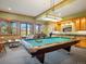 Entertainment haven with a billiard table, scenic mountain views, custom bar, and comfortable seating at 3395 Timbergate Trl, Evergreen, CO 80439