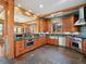 Spacious kitchen with stone flooring, wooden cabinets, and stainless steel appliances at 3395 Timbergate Trl, Evergreen, CO 80439