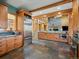 Gourmet kitchen boasting stainless steel appliances, custom cabinets, and stone tile flooring at 3395 Timbergate Trl, Evergreen, CO 80439