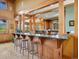 Open-concept kitchen with island, stainless steel appliances, and wood cabinets at 3395 Timbergate Trl, Evergreen, CO 80439