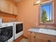Well-equipped laundry room featuring modern appliances and a utility sink at 3395 Timbergate Trl, Evergreen, CO 80439