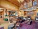 Spacious living room with wood floors, high ceilings, and a cozy seating area at 3395 Timbergate Trl, Evergreen, CO 80439