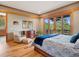 Comfortable main bedroom with a private balcony overlooking a tranquil forested landscape at 3395 Timbergate Trl, Evergreen, CO 80439