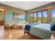 Bright main bedroom featuring a sitting area and sliding doors to a balcony with scenic views at 3395 Timbergate Trl, Evergreen, CO 80439