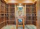 Custom wine cellar with beautiful stone accents, wood shelving and center table perfect for the wine enthusiast at 3395 Timbergate Trl, Evergreen, CO 80439