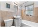 Bathroom with white sink, tiled walls, tub, and natural lighting at 2100 N Franklin St # 5, Denver, CO 80205