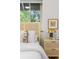 Cozy bedroom featuring wicker bedside table, natural light, and garden view at 2100 N Franklin St # 5, Denver, CO 80205