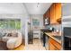 Open kitchen and living space with stainless steel appliances, and cozy seating area with lots of natural light at 2100 N Franklin St # 5, Denver, CO 80205