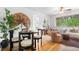 Open concept living room features hardwood floors, stylish furnishings, and access to the dining area at 2100 N Franklin St # 5, Denver, CO 80205