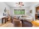 Bright living room features a ceiling fan, hardwood floors, modern furnishings, and a large window with tree views at 2100 N Franklin St # 5, Denver, CO 80205