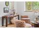 Bright living room with a hardwood floor features a stylish desk with unique decor and furnishings at 2100 N Franklin St # 5, Denver, CO 80205
