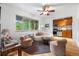 Sun-lit living room features a ceiling fan, hardwood floors, stylish furnishings, and a large window at 2100 N Franklin St # 5, Denver, CO 80205