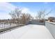 Spacious rooftop deck covered in snow with city views at 2140 Newton St, Denver, CO 80211