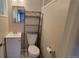 Clean bathroom with a vanity, toilet, and shelving unit at 2998 S York St, Denver, CO 80210