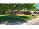 Brick ranch house with a lush lawn and mature trees at 2998 S York St, Denver, CO 80210