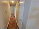 Long hallway with hardwood floors leading to bedrooms at 2998 S York St, Denver, CO 80210