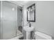 Basement bathroom with walk-in shower and pedestal sink at 2538 S Dover Way, Lakewood, CO 80227