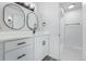 Modern bathroom featuring dual sinks, white cabinets, black hardware, and a walk-in shower at 2538 S Dover Way, Lakewood, CO 80227