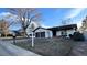 Charming single-story home featuring a two-car garage and mature tree at 2538 S Dover Way, Lakewood, CO 80227