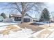 Two-story home with a gray and white exterior, two-car garage, and landscaping at 2538 S Dover Way, Lakewood, CO 80227