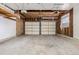 Spacious garage with two-car access and unfinished ceiling and walls at 2538 S Dover Way, Lakewood, CO 80227