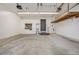 Clean two-car garage with storage cabinets, shelving, and access door to the yard at 2538 S Dover Way, Lakewood, CO 80227