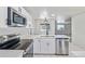 Modern kitchen with stainless steel appliances, white cabinetry and tile flooring at 2538 S Dover Way, Lakewood, CO 80227