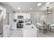 Bright kitchen featuring stainless appliances, white cabinets, and eat in table at 2538 S Dover Way, Lakewood, CO 80227