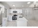 Modern kitchen with white cabinets, stainless steel appliances, and island at 2538 S Dover Way, Lakewood, CO 80227