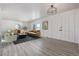 Bright living room with neutral paint, modern lighting, wood flooring, and white double doors at 2538 S Dover Way, Lakewood, CO 80227