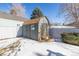 Backyard shed featuring board and batten siding and composition roof at 2538 S Dover Way, Lakewood, CO 80227