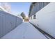 Snowy side yard with fence and shed view at 2538 S Dover Way, Lakewood, CO 80227