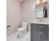 Modern powder room with gray vanity and marble countertop at 521 Milwaukee St, Denver, CO 80206