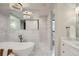 Elegant bathroom featuring a soaking tub, marble tile, and a large mirror at 521 Milwaukee St, Denver, CO 80206