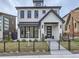 Stylish two-story home with a white brick exterior and black metal fence at 521 Milwaukee St, Denver, CO 80206