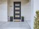 Modern front door with black frame and white brick exterior at 521 Milwaukee St, Denver, CO 80206