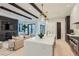 Open concept kitchen with white and dark cabinetry, large island, and high-end appliances at 521 Milwaukee St, Denver, CO 80206