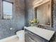 Stylish powder room with dark wallpaper, modern vanity, and a contemporary toilet at 521 Milwaukee St, Denver, CO 80206